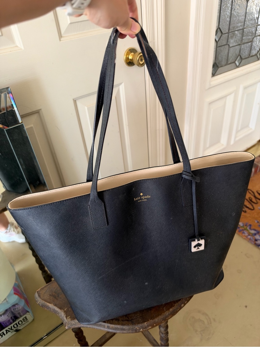 kate spade black tote with beige trim and gold logo
